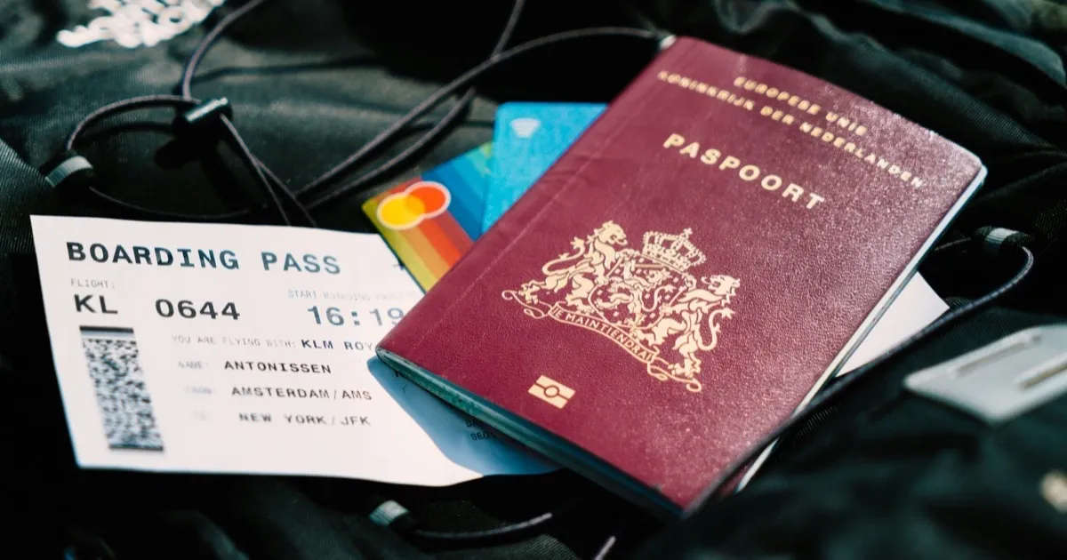 Open suitcase with passport and Ibiza-bound boarding pass — Marbella escort travel companion booking guide 2026