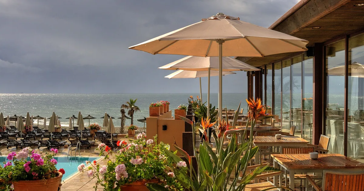 Hotel Guadalmina's terrace with parasols overlooking the pool and the sea at Marbella — charity galas guide