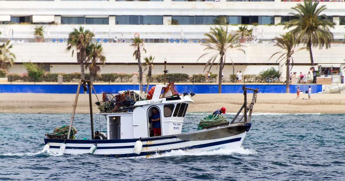 A small fishing boat by a beach in Marbella, Spain — Escorts for Events, 2026 guide
