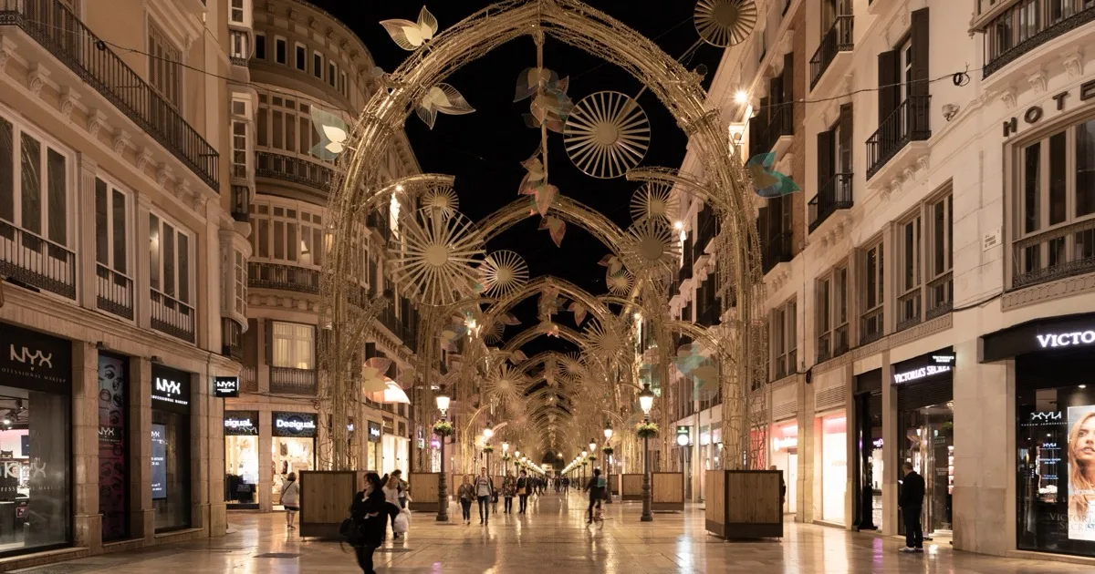Calle Marqués de Larios, the main pedestrian shopping street in Málaga's historic centre, lit up at night — Málaga city centre escorts guide 2026