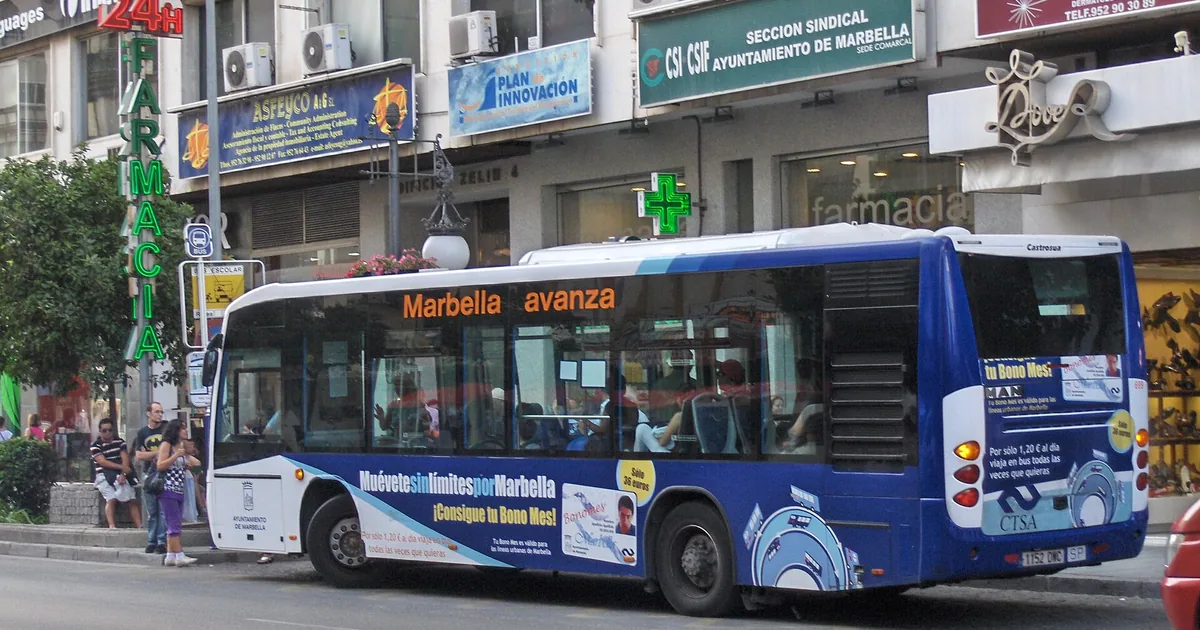 Blue Avanza urban bus on a street in central Marbella — public transport to Puerto Banús