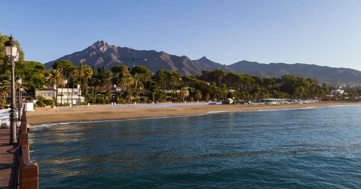 Playa de Nagüeles on Marbella's Golden Mile, the beach fronting the Marbella Club and Puente Romano resorts — escort-friendly hotels guide 2026